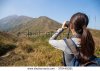 stock-photo-back-view-of-woman-looking-through-binoculars-370448381.jpg