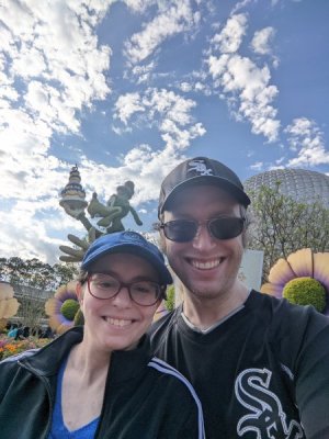 Kristin and Steve at EPCOT standing in front a topiary of Goofy at the flower and garden festival