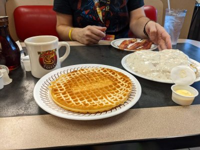 Waffle house waffle, cup of coffee, biscuits and gravy and bacon from a Waffle House outside Indianapolis, IN