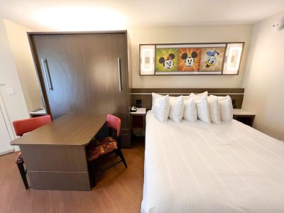 Disneys-All-Star-Movie-Resort-Preferred-room-queen-bed-and-desk.jpg