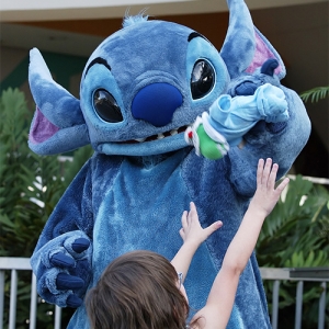 Stitch plays with a doll