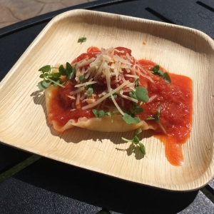 Ricotta And Zucchini Raviolo Served With Rustic Tomato Sauce