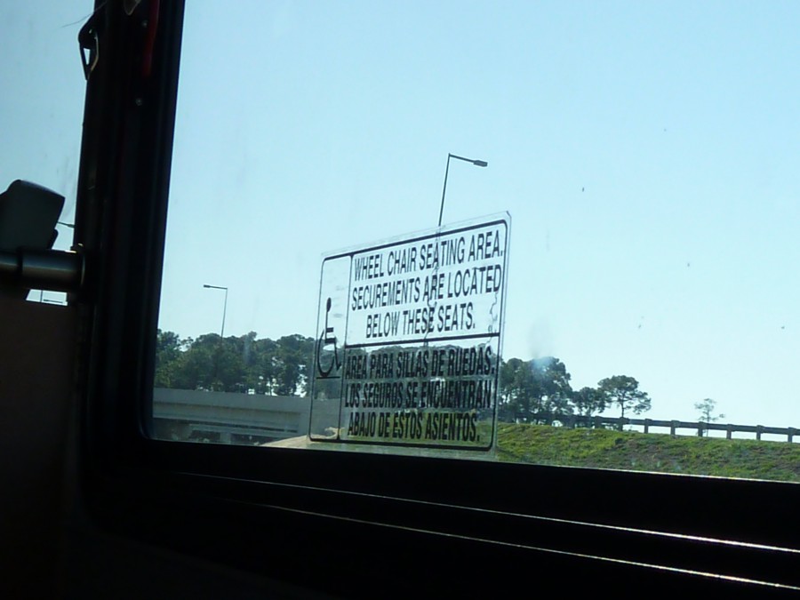 Bus sign above wheelchair spots