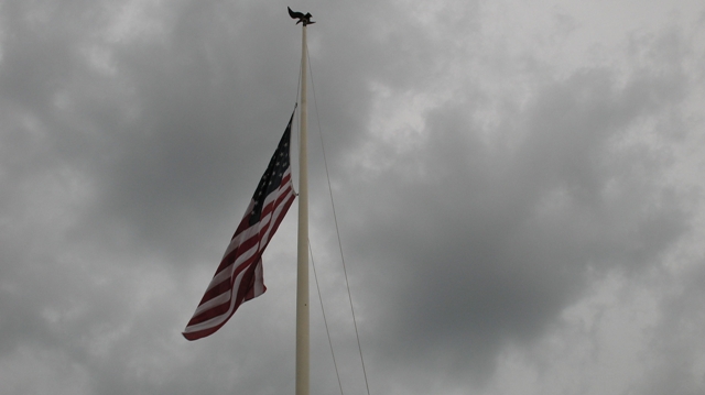 Cloudy day taking down the flag.