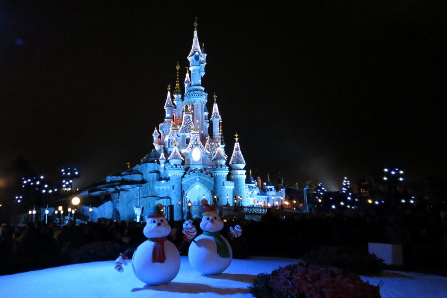 Snowmen in front of castle at night