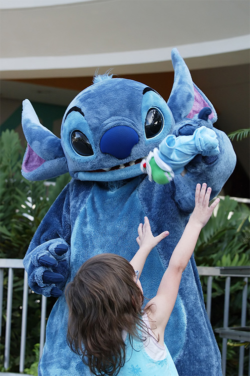 Stitch plays with a doll