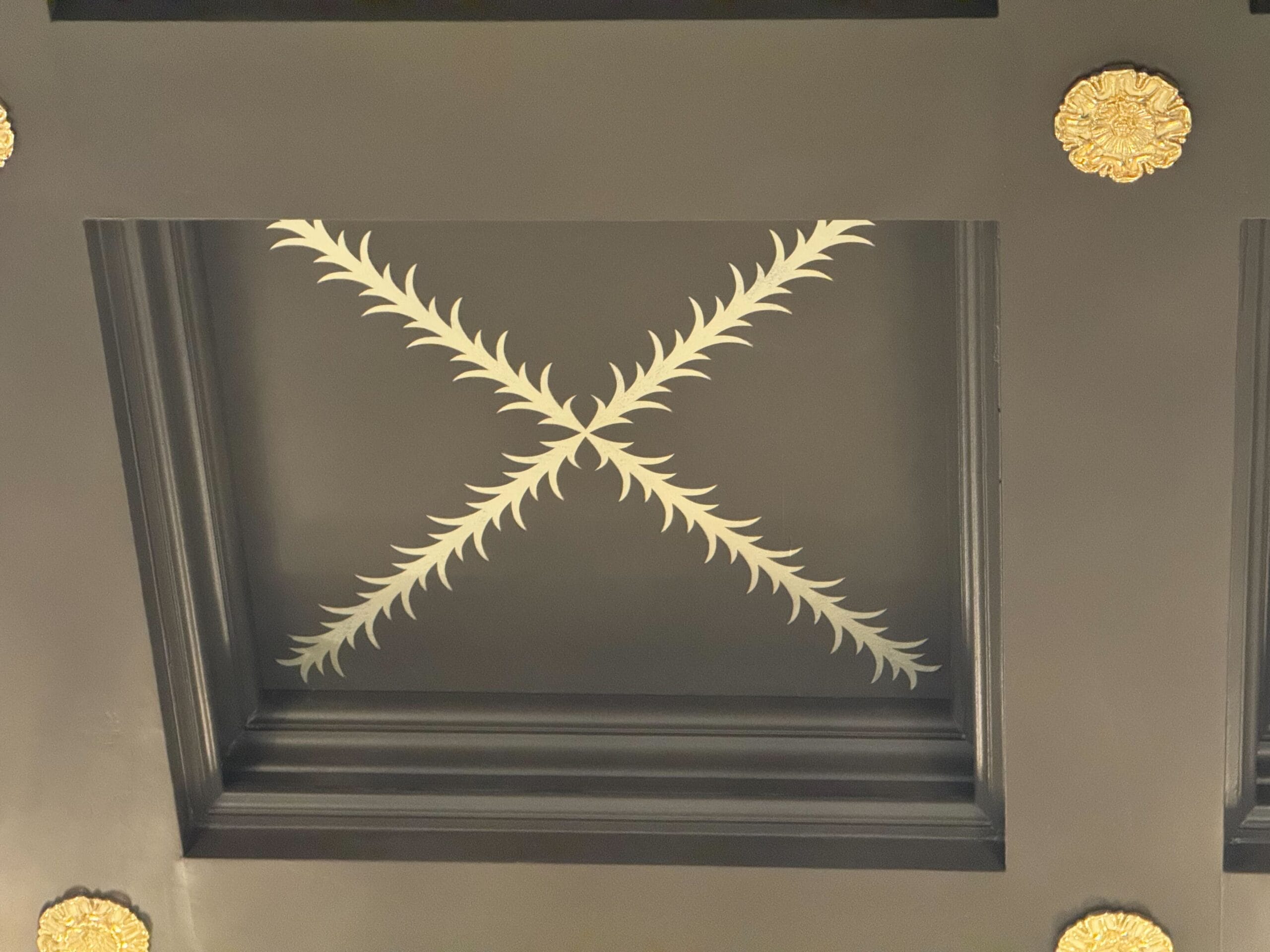 These finely painted details are X's comprised of feathered lines, a nod to the bar's overall theming. The Perch is fashioned in homage to the large birdcage that formerly sat in the lobby. The feathery details are on every one of the bar's ceiling tiles. 