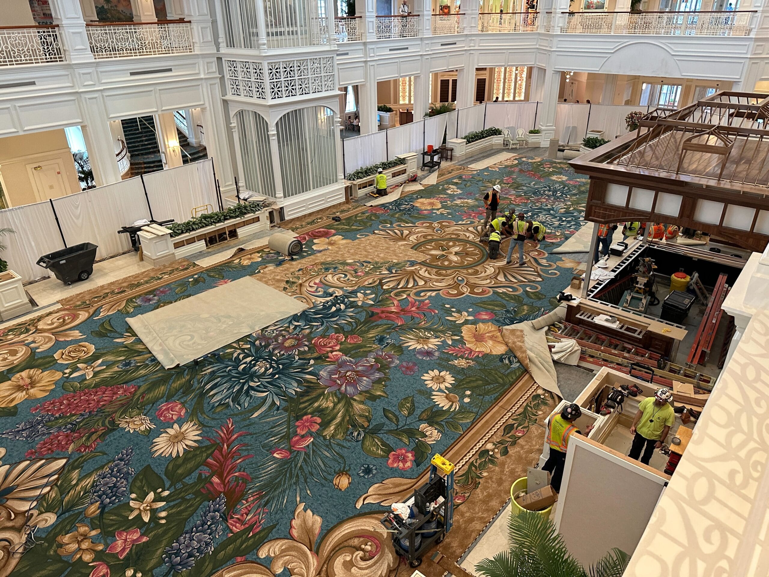 Cast Members update the vibrant floral carpet in Disney’s Grand Floridian lobby, known for its airy ceilings and elegant white walls.