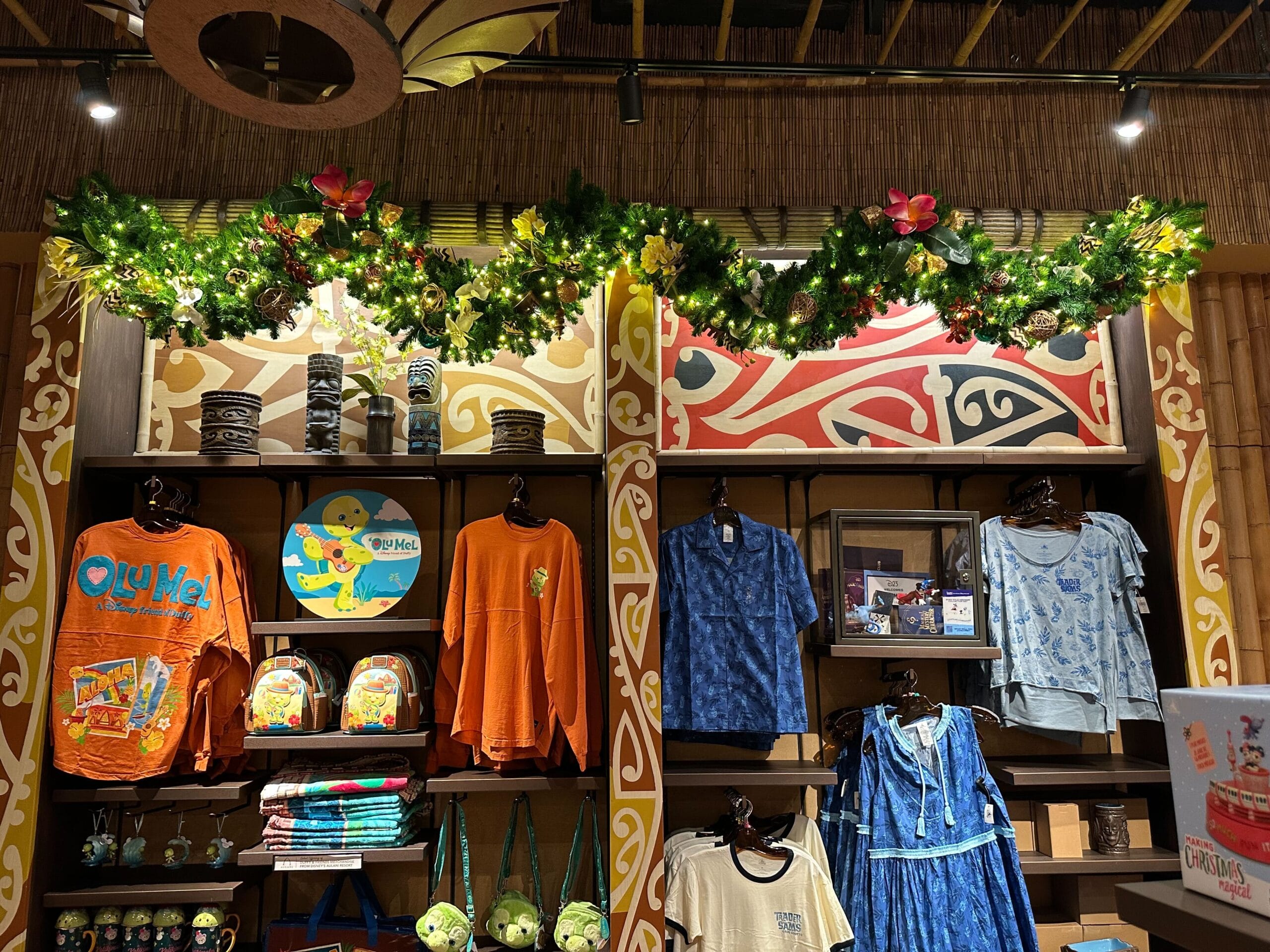 A store display featuring tropical-themed decorations, shirts, and merchandise on shelves.