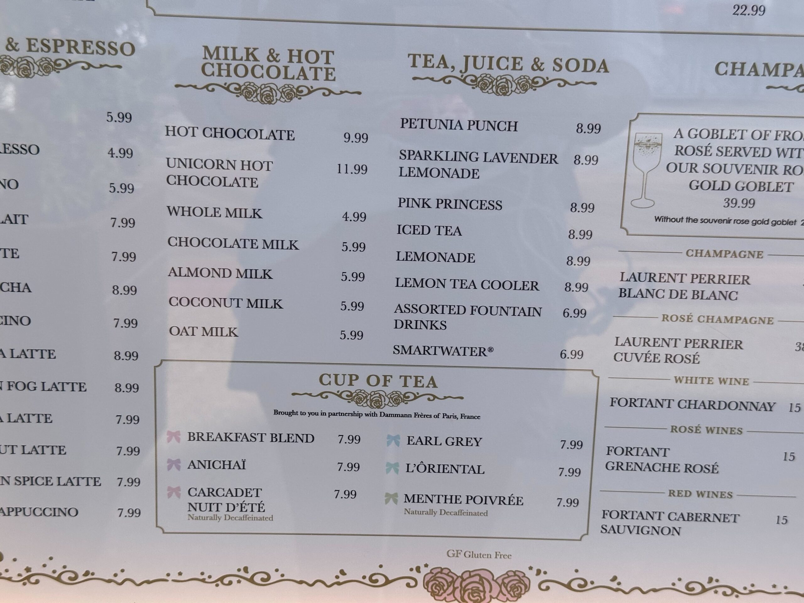 Explore our delightful menu at the cake bake shop, showcasing a variety of beverages: freshly brewed coffees, indulgent hot chocolates, creamy milk options, aromatic teas, refreshing juices, and select wines—all with prices conveniently listed in U.S. dollars.
