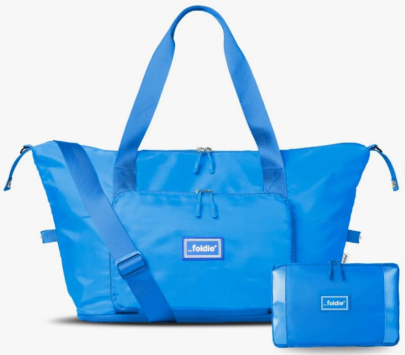 a bright blue tote bag with it's smaller folded up form beside it