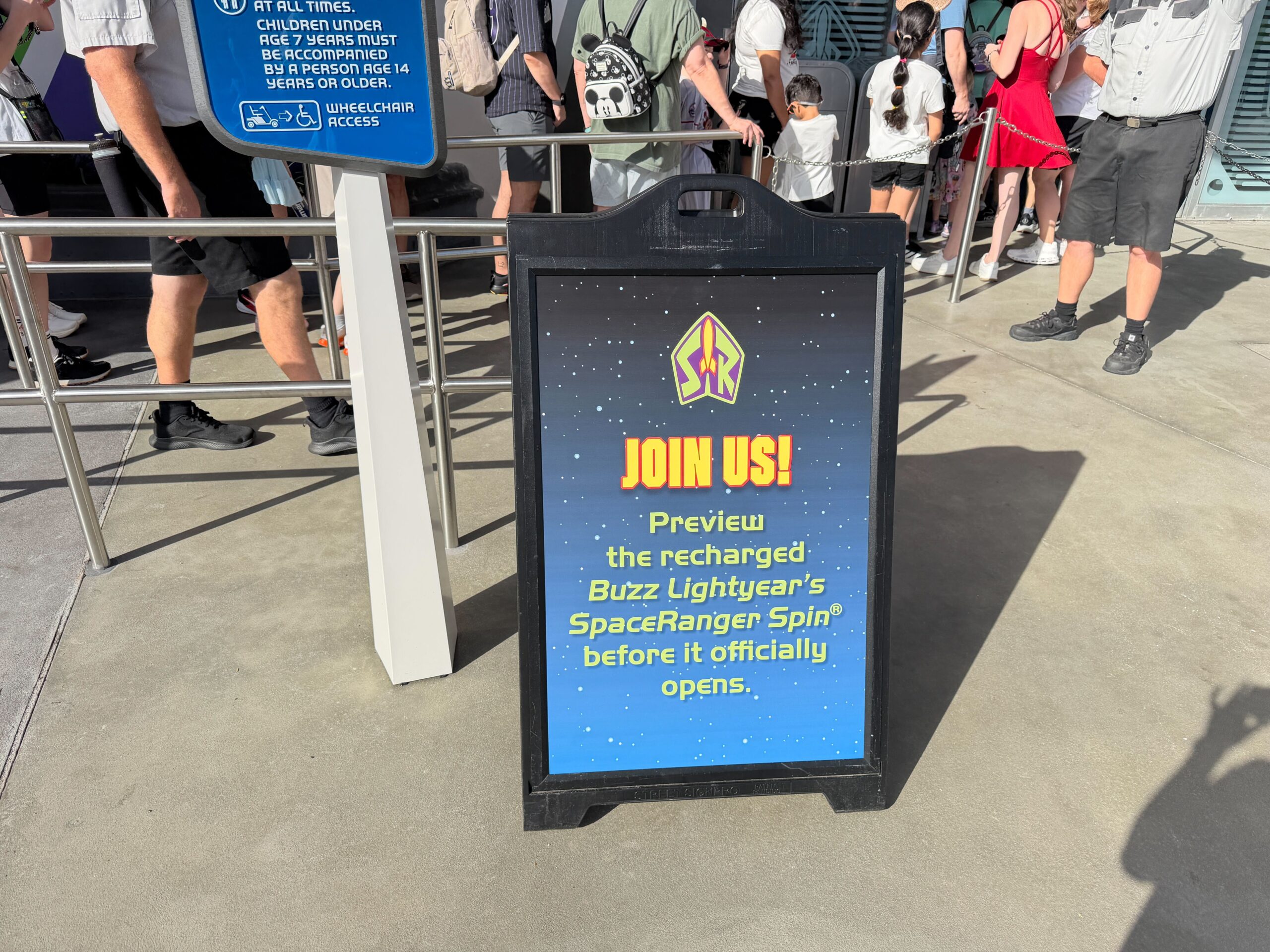 A sign outside reads, Join us! Preview the recharged Buzz Lightyear's Space Ranger Spin before it official opens.