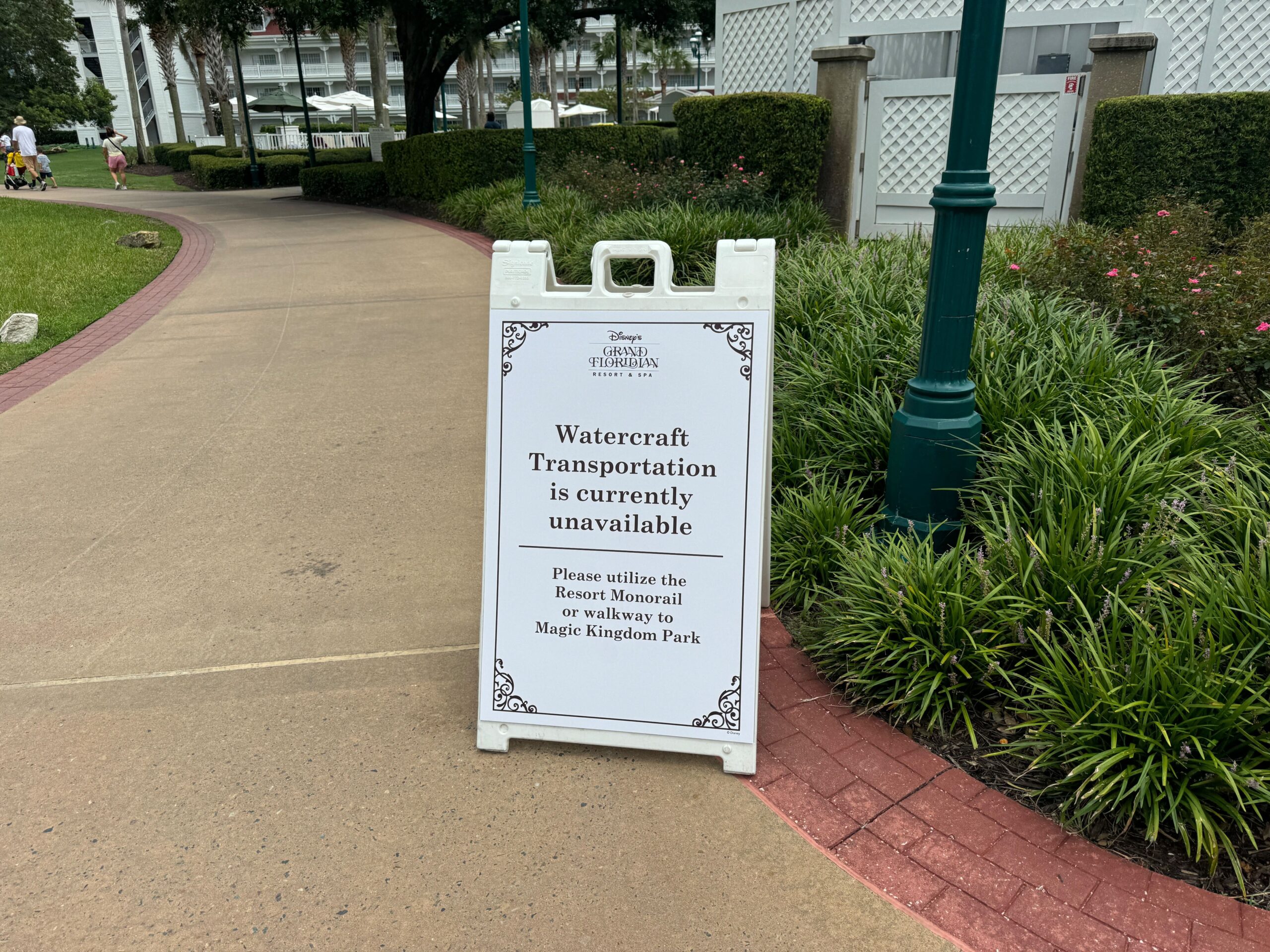 A sign at a Disney resort informs guests that watercraft transportation is unavailable and directs them to use the Resort Monorail or walkway to Magic Kingdom Park.