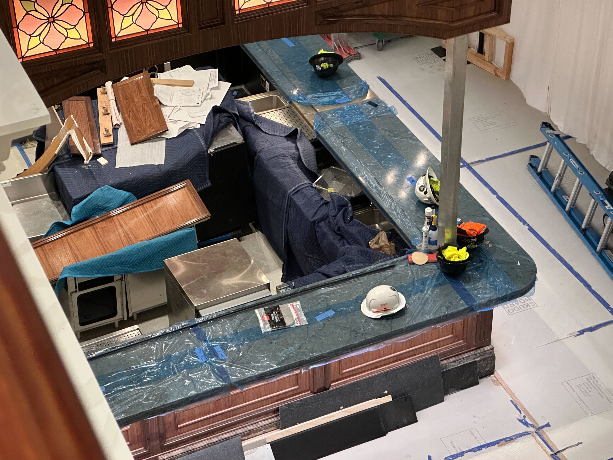 Bar at Grand Floridian Disney Resort under construction with hard hats, tools, and blue tarps on the counters.