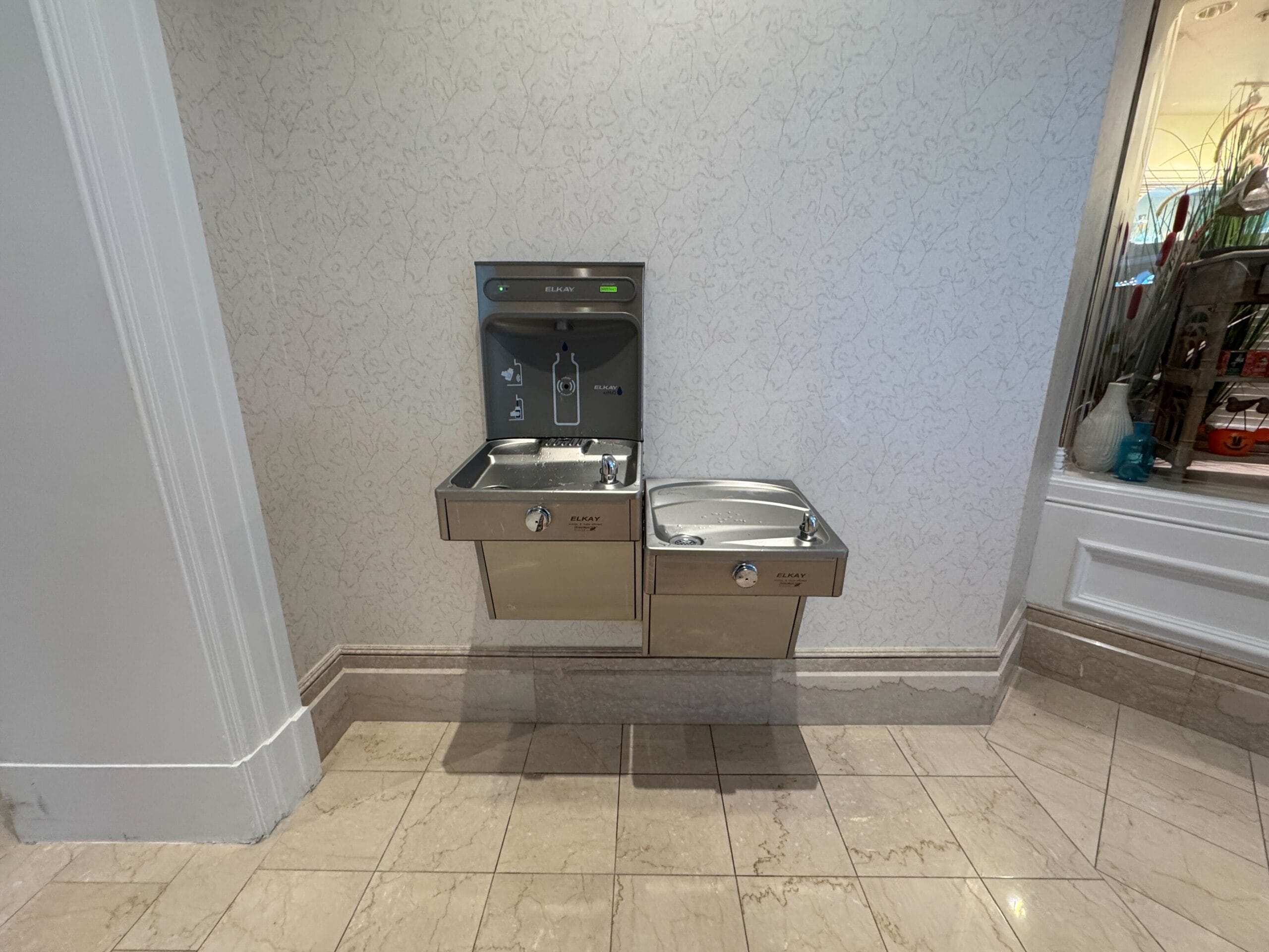 Two stainless steel fountains with a bottle filler in Disney’s Grand Floridian Resort lobby, near Magic Kingdom’s Cinderella Castle.