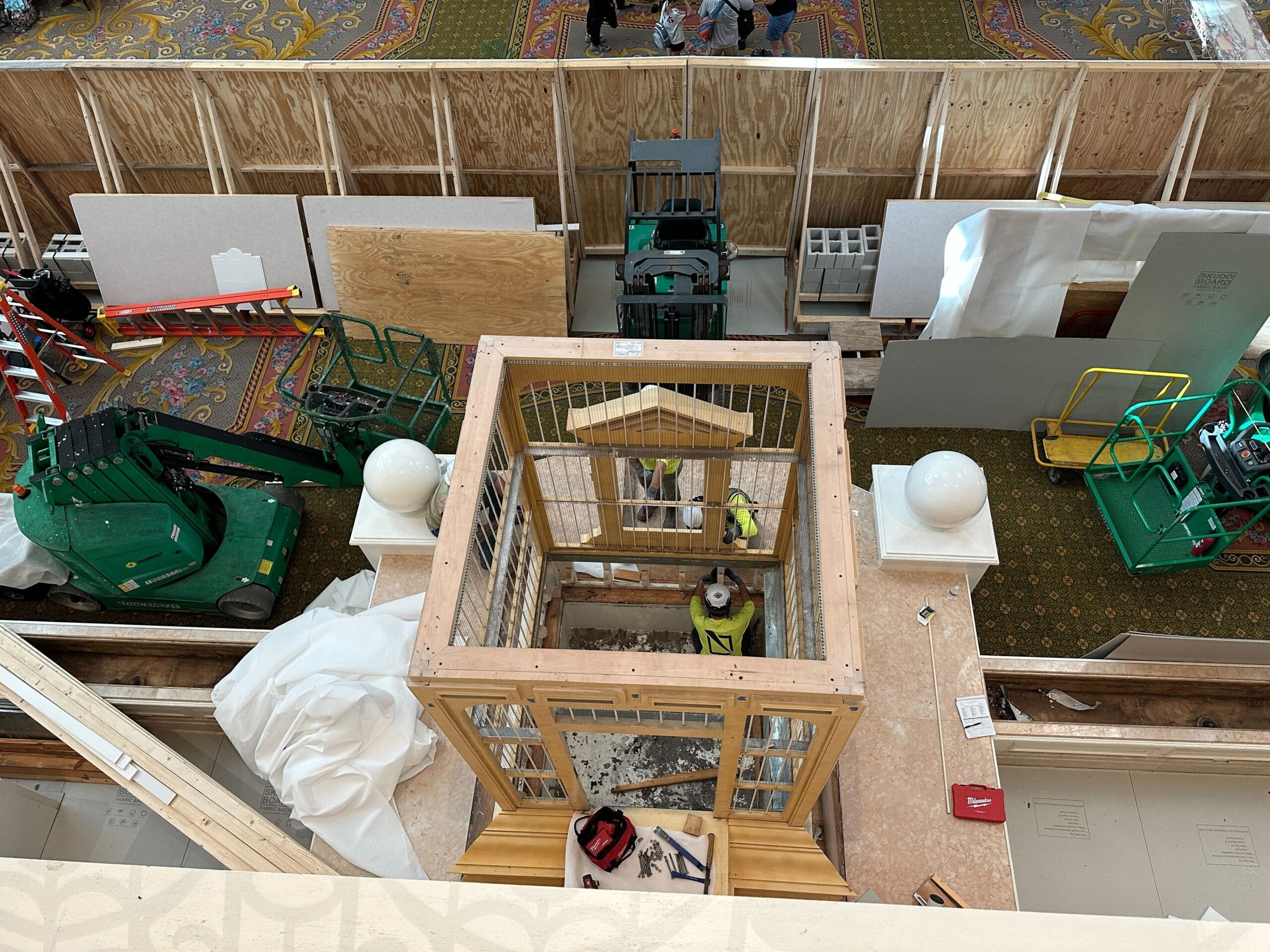Aerial view of the Grand Floridian Resort lobby remodel with workers and the birdcage dismantled at the center.
