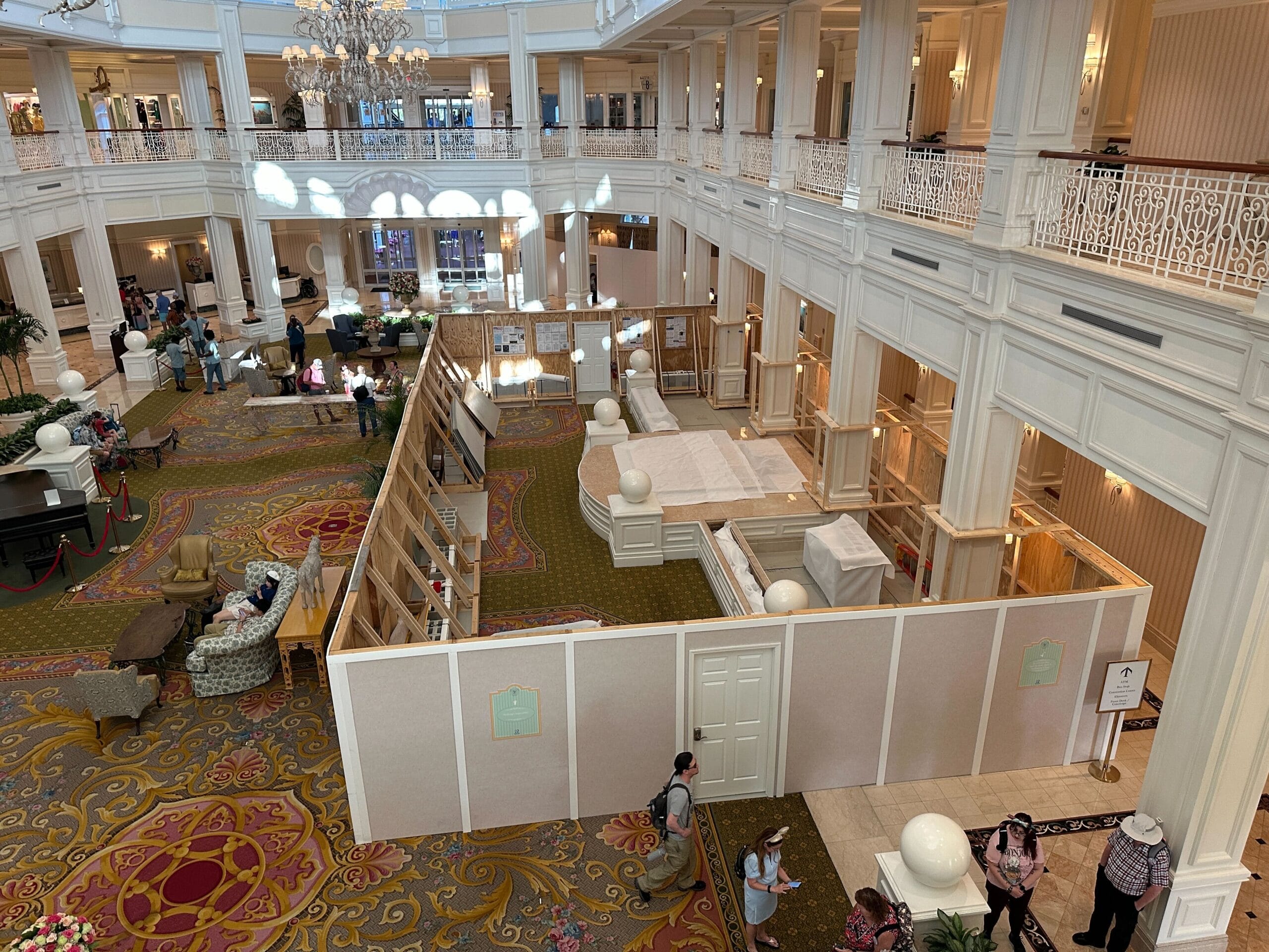 Lobby area with elegant decor, construction walls, and a birdcage at Disney’s Grand Floridian Resort.