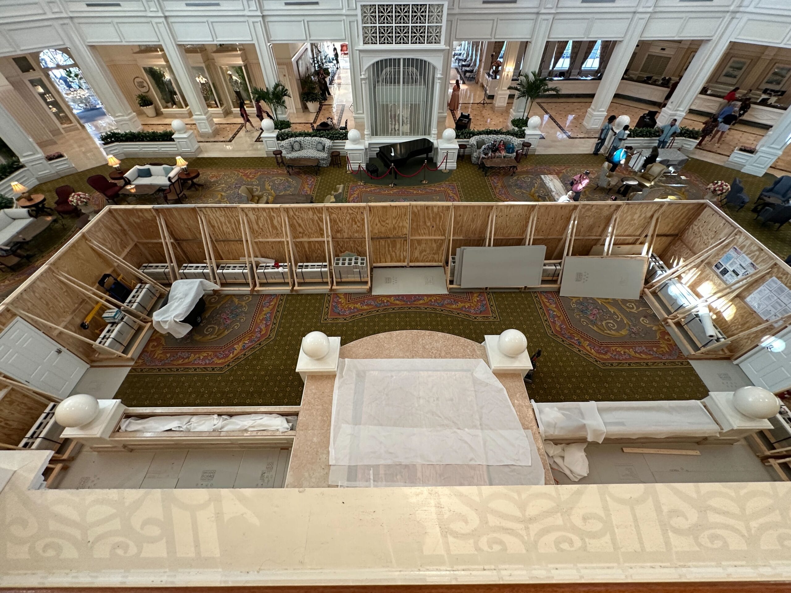 The Grand Floridian Resort lobby is under renovation, with birdcage barriers and furniture draped in white sheets.
