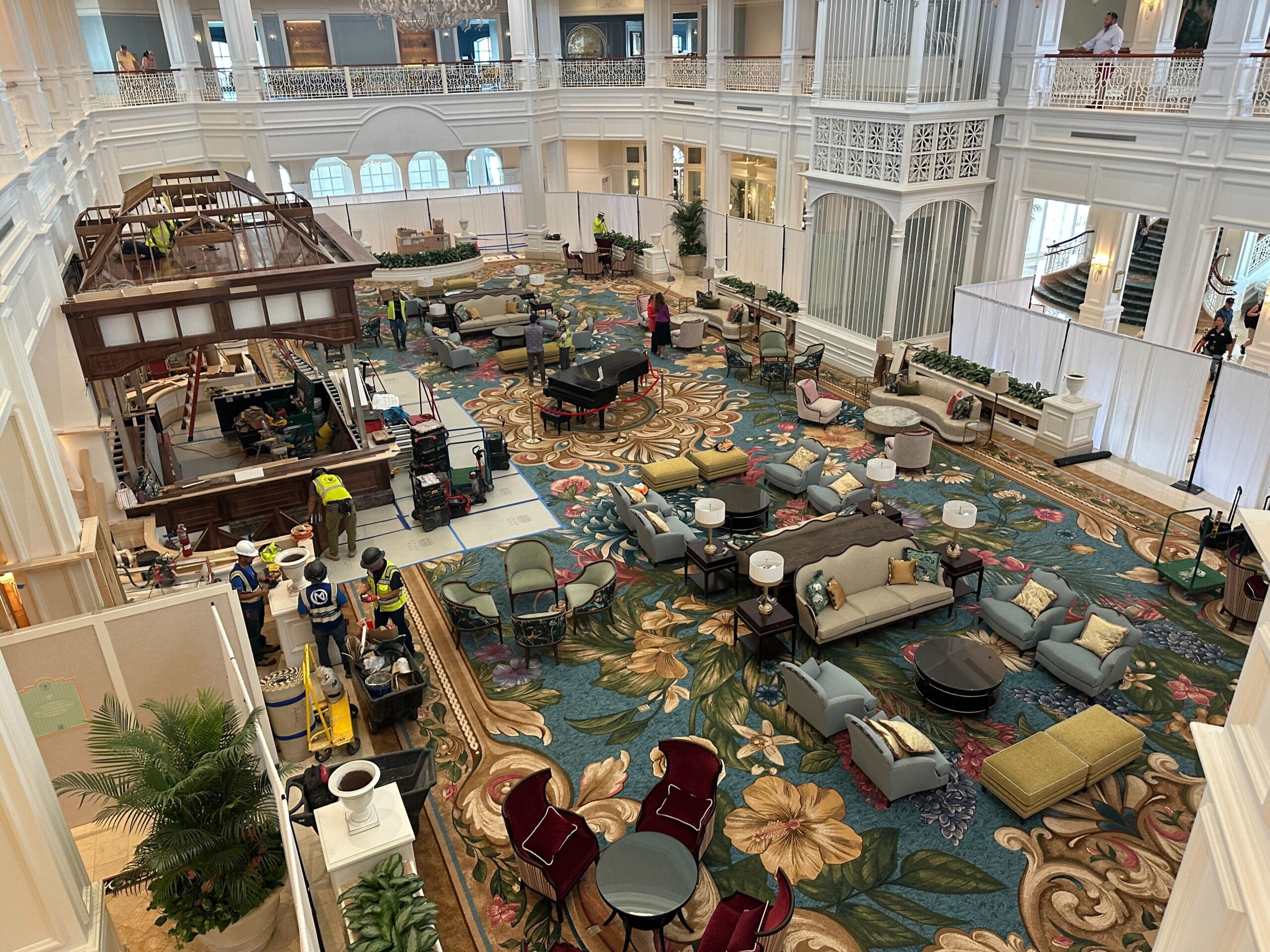 Grand Floridian Resort lobby with elegant furniture, floral carpet, and construction by the bar—no castle like Magic Kingdom’s nearby.