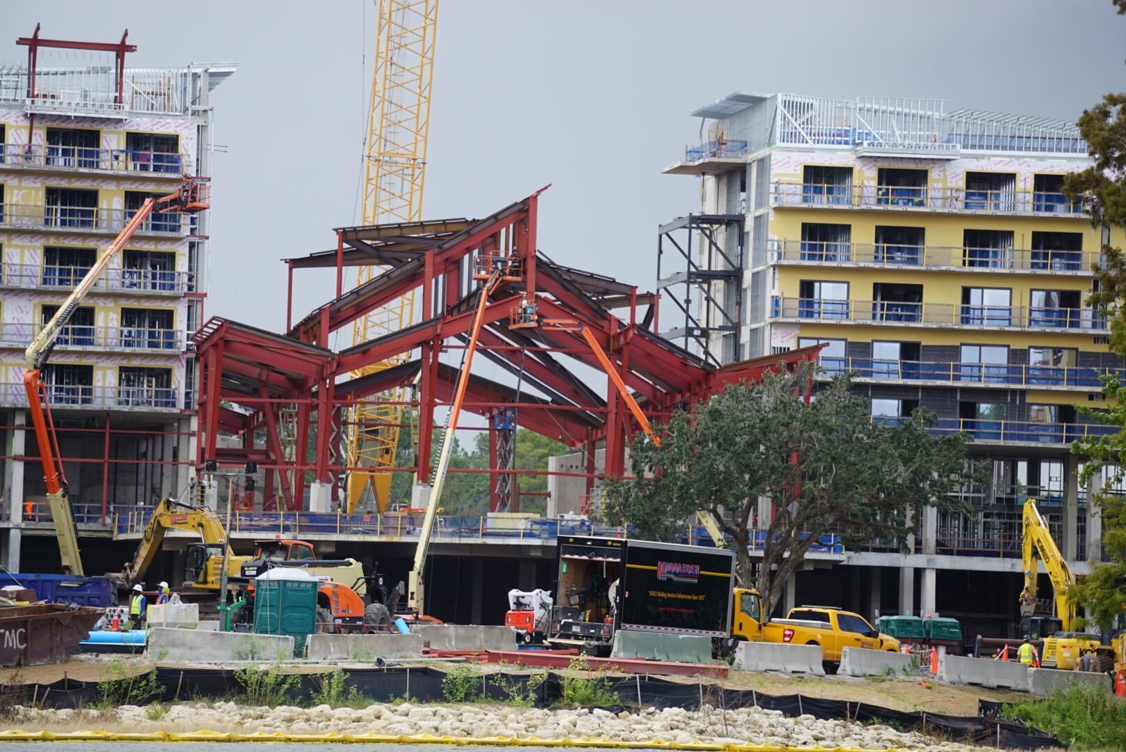 Construction Updates: Progress at Lakeshore Lodge shows cranes, steel beams, and workers active on site.
