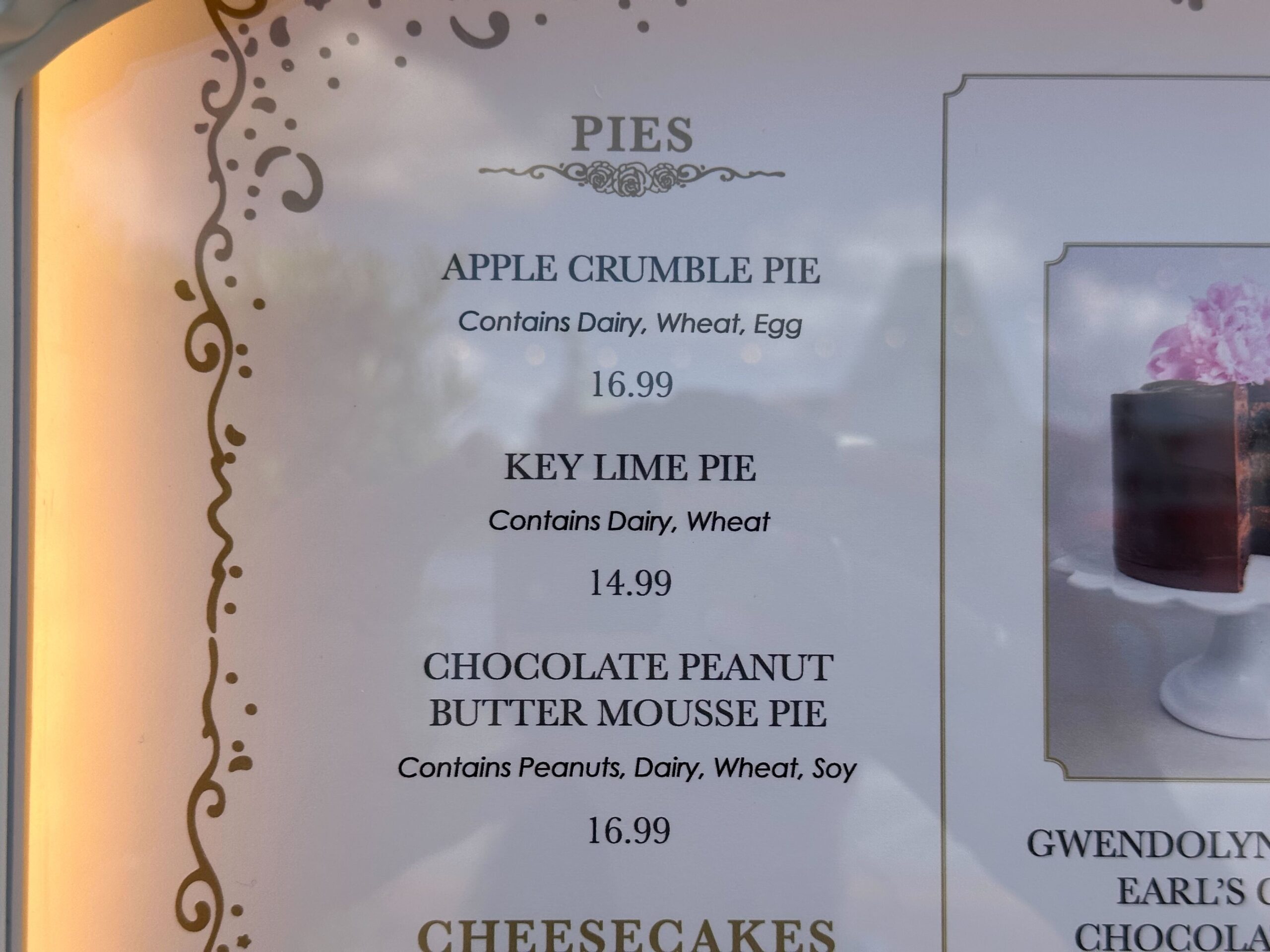 At the Cake Bake Shop, our menu features three delightful pies: the Apple Crumble Pie ($16.99), Key Lime Pie ($14.99), and Chocolate Peanut Butter Mousse Pie ($16.99), all with detailed allergen information for a worry-free indulgence.