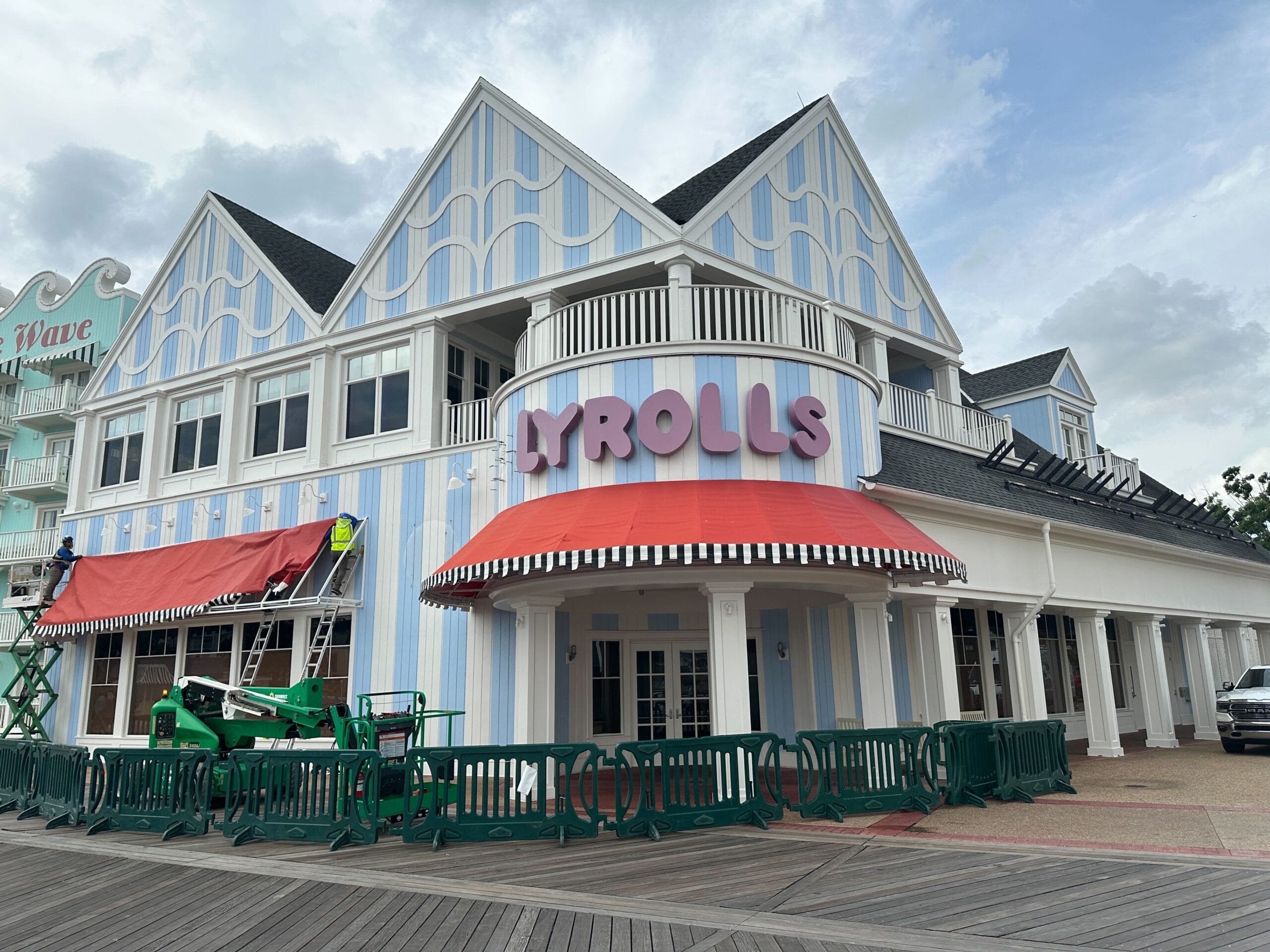 A pastel blue and white striped building with Jellyrolls Awnings and bold PYROLLS signage above the entrance.