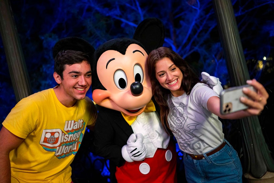 Mickey Mouse posing with guests at Disney After Hours Event at Walt Disney World Resort