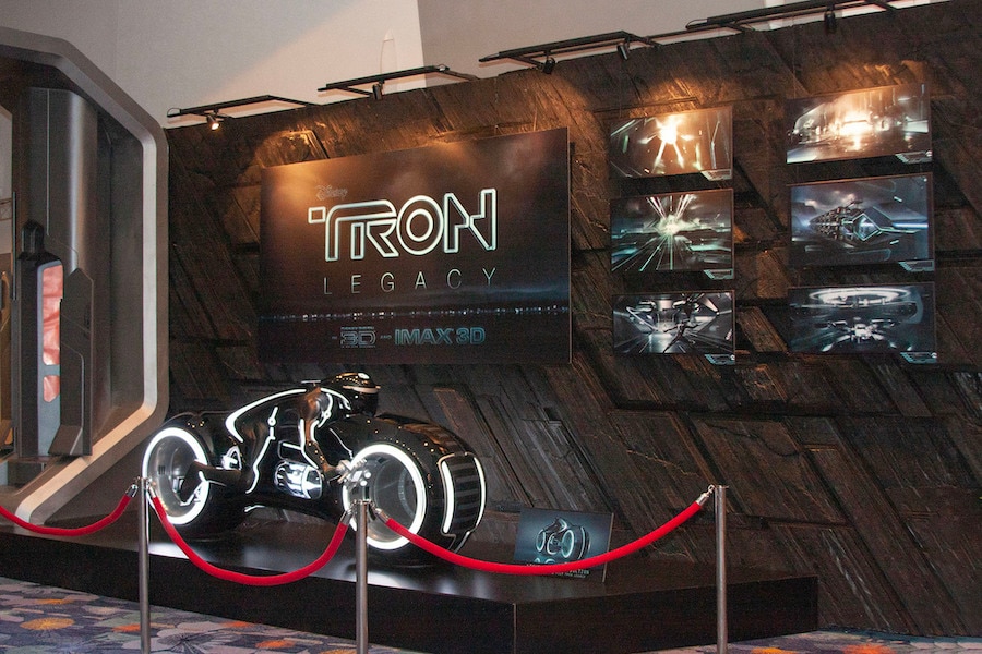 Lightcycle from “TRON: Legacy” on display at D23 Expo 2009 in front of a wall containing concept artwork from the film and the film’s logo. Lightcycle from “TRON: Legacy” on display at D23 Expo 2009 in front of a wall containing concept artwork from the film and the film’s logo.