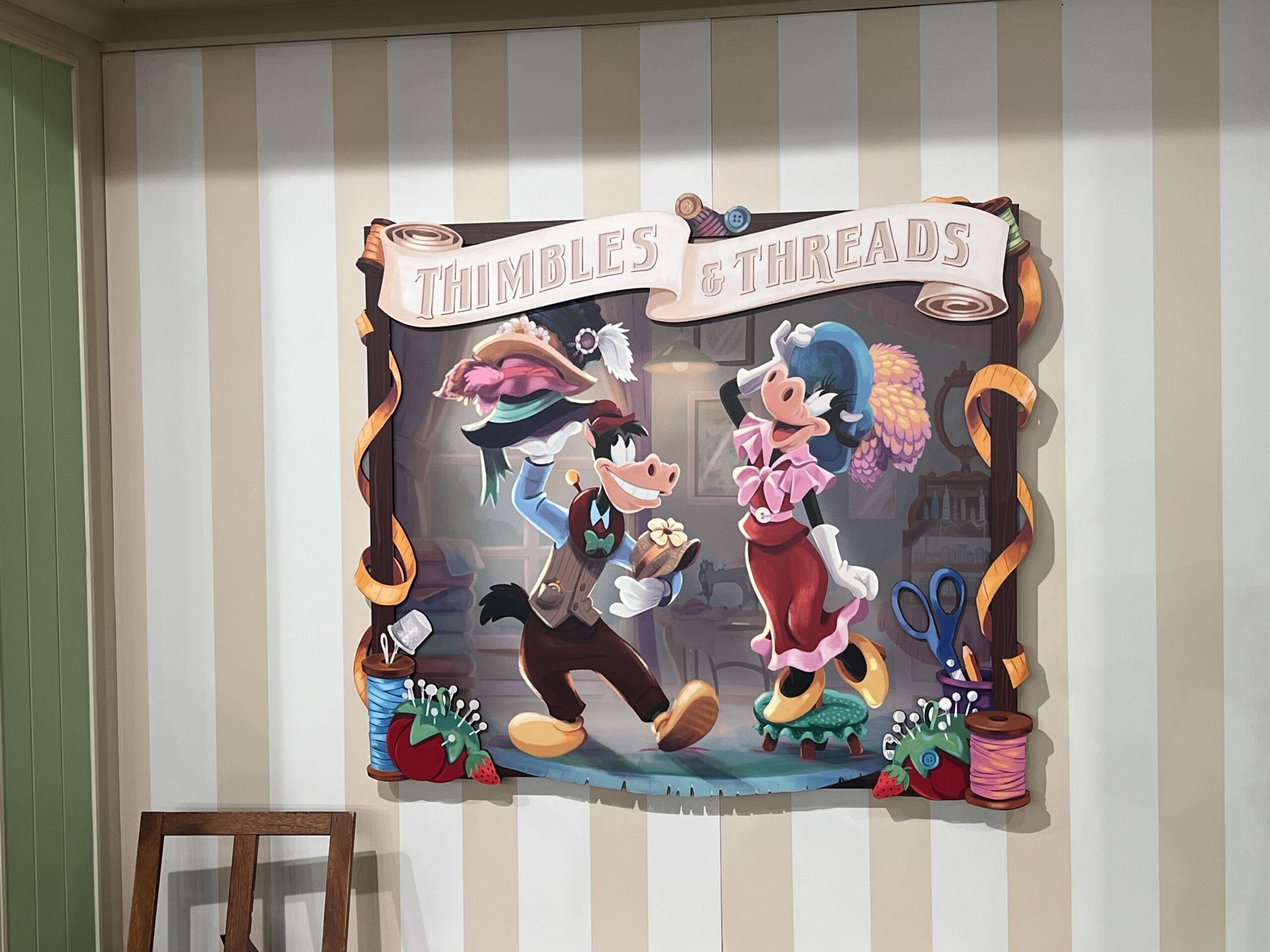 Cartoon cows dressed as tailors dance under a “Thimbles & Threads” sign at Screen Door General Store, sewing items abound. Cartoon cows dressed as tailors dance under a “Thimbles & Threads” sign at Screen Door General Store, sewing items abound.