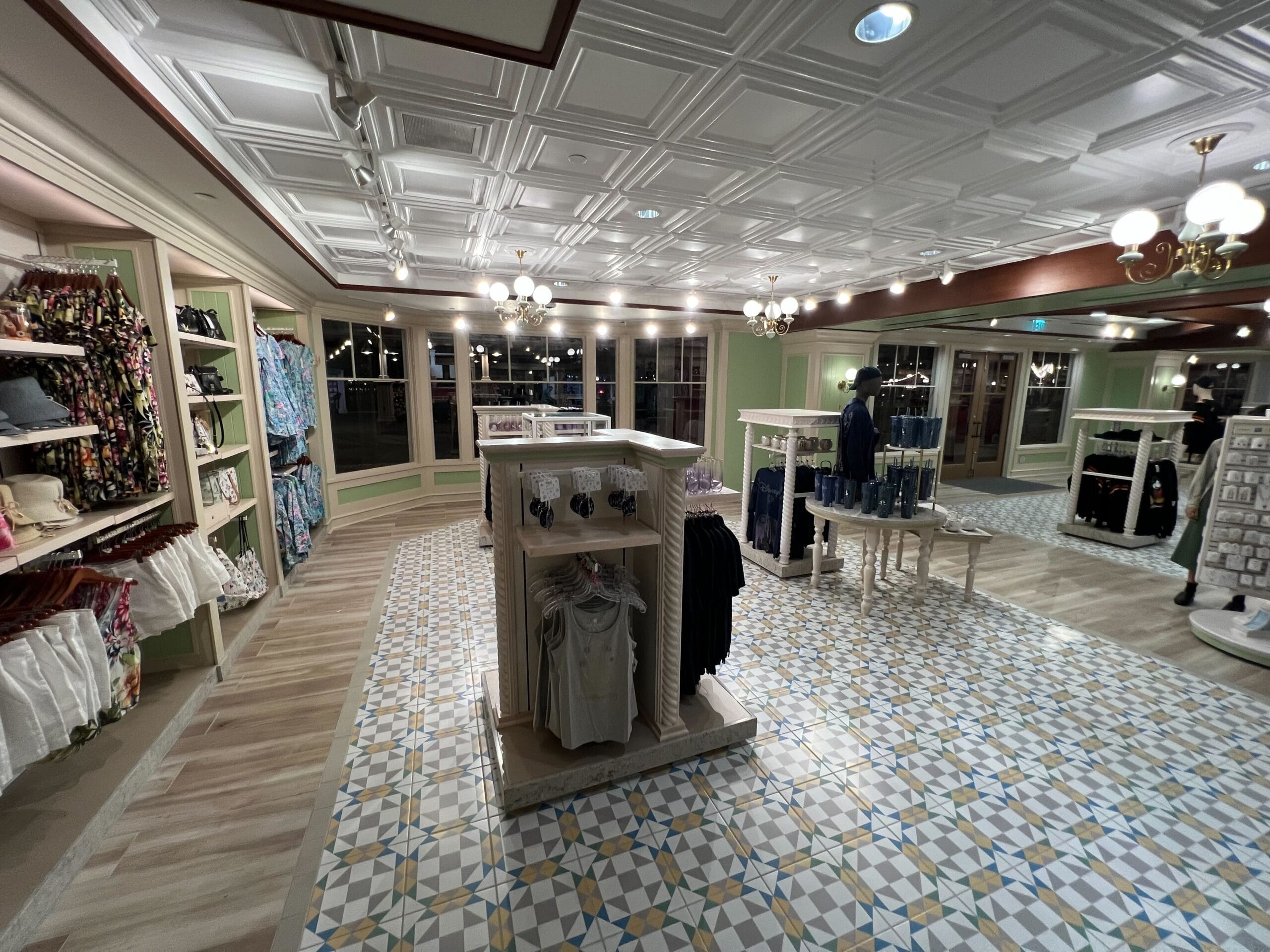 A brightly lit boutique, Thimbles & Threads, with patterned tile floors, racks, and shelves displaying accessories and apparel. A brightly lit boutique, Thimbles & Threads, with patterned tile floors, racks, and shelves displaying accessories and apparel.