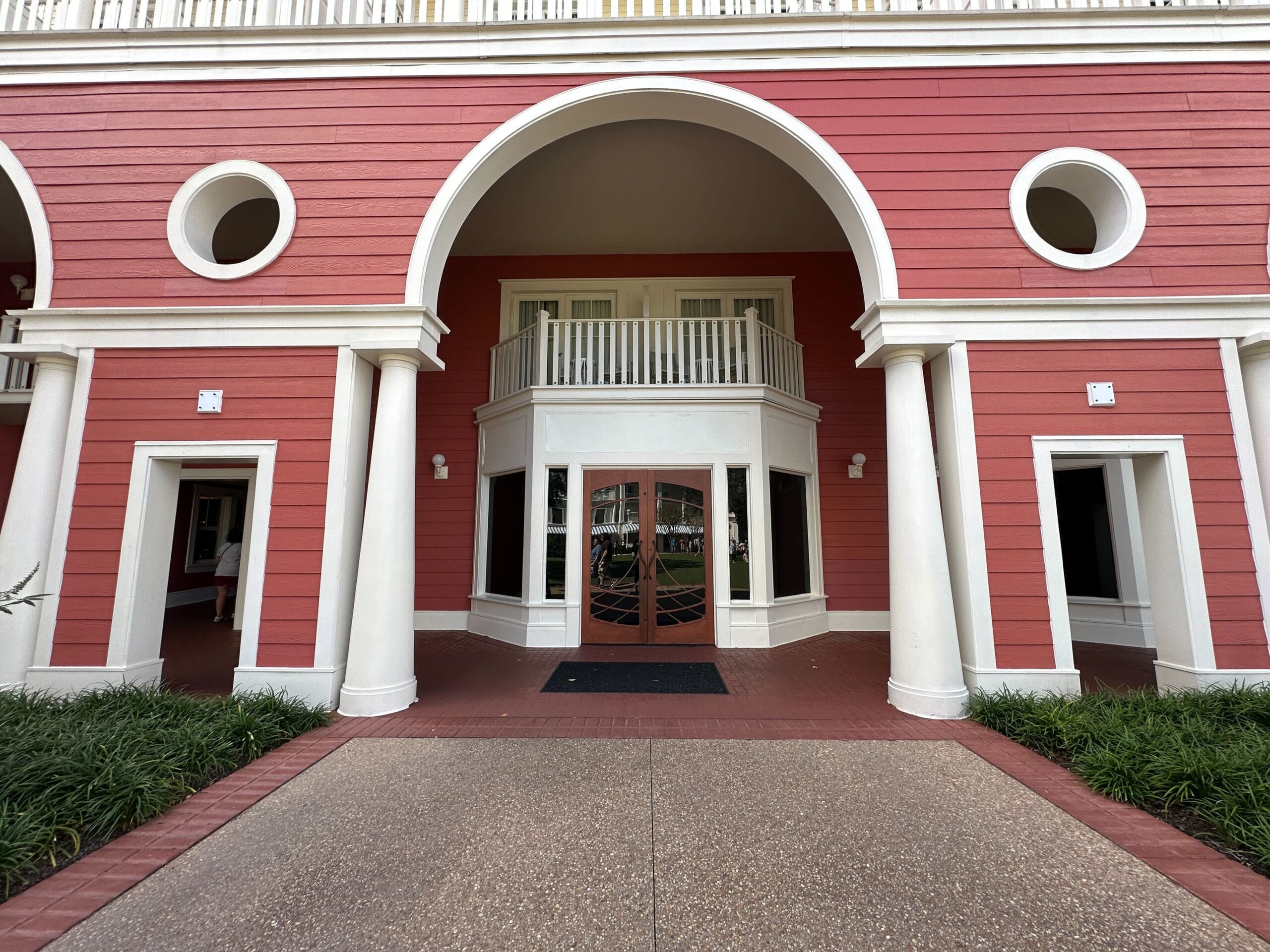 A red building with white columns and arched entryway at Disney’s BoardWalk Resort, not a castle like those found in Disney parks. A red building with white columns and arched entryway at Disney’s BoardWalk Resort, not a castle like those found in Disney parks.
