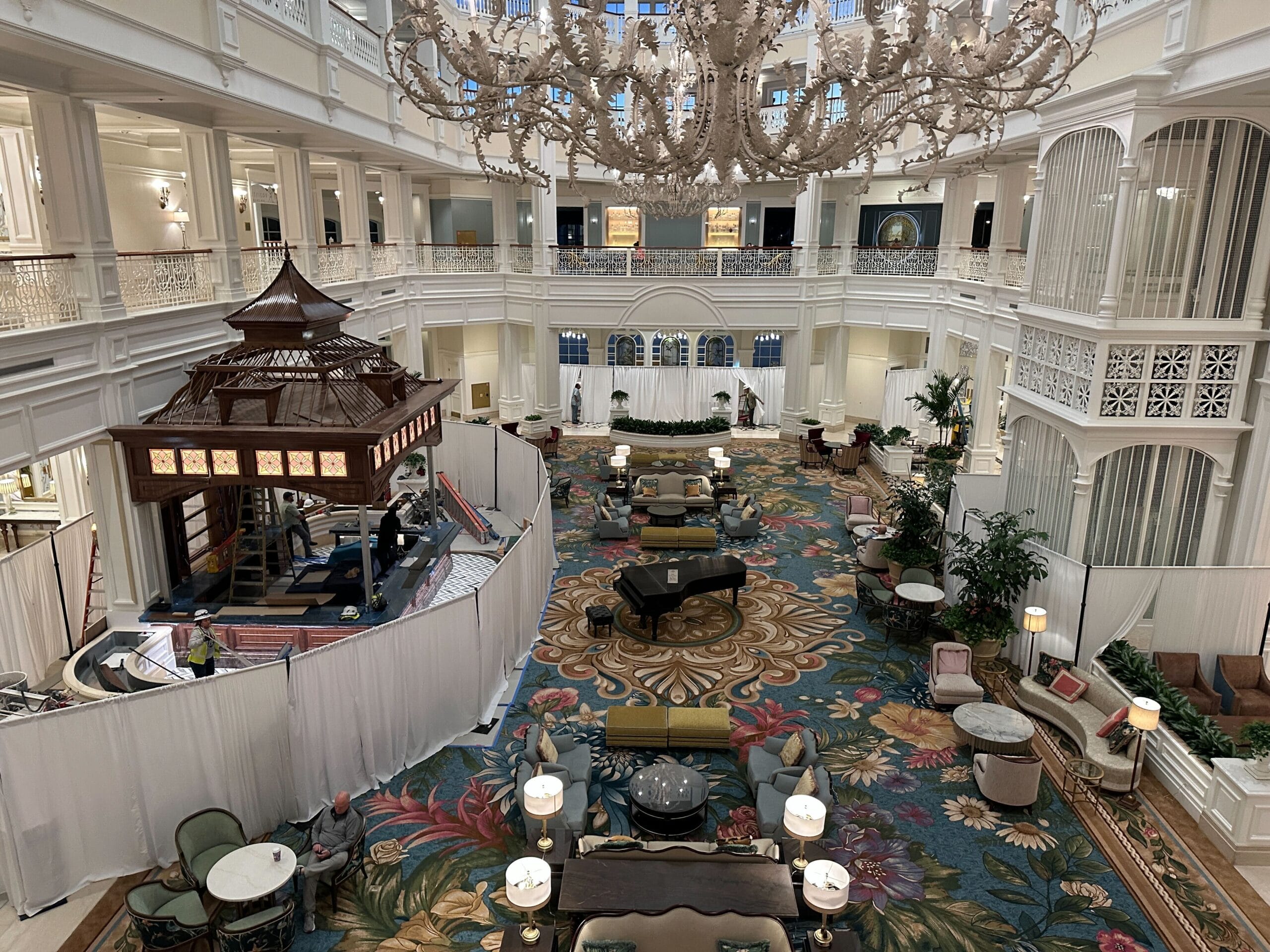 Refined Grand Floridian lobby at Walt Disney World, featuring a grand piano, ornate chandelier, floral carpet, and white railings. Refined Grand Floridian lobby at Walt Disney World, featuring a grand piano, ornate chandelier, floral carpet, and white railings.