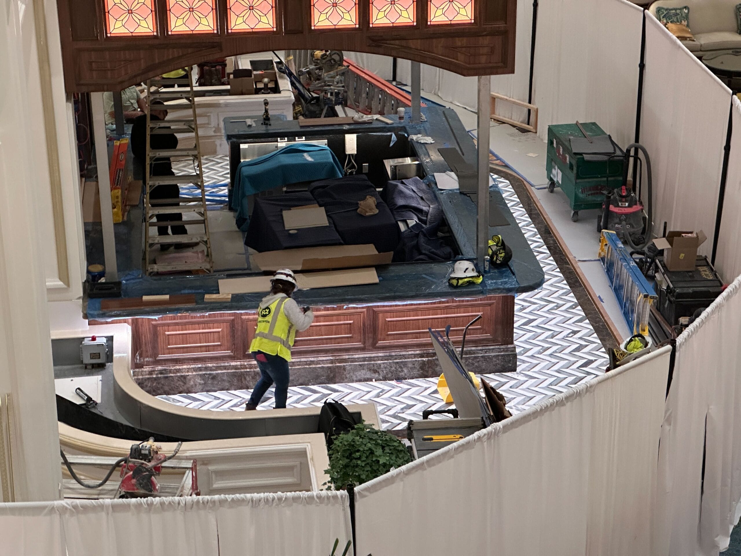 A construction worker in a safety vest walks through the Grand Floridian site, floor exposed—no castle spires like Disney’s iconic parks. A construction worker in a safety vest walks through the Grand Floridian site, floor exposed—no castle spires like Disney’s iconic parks.