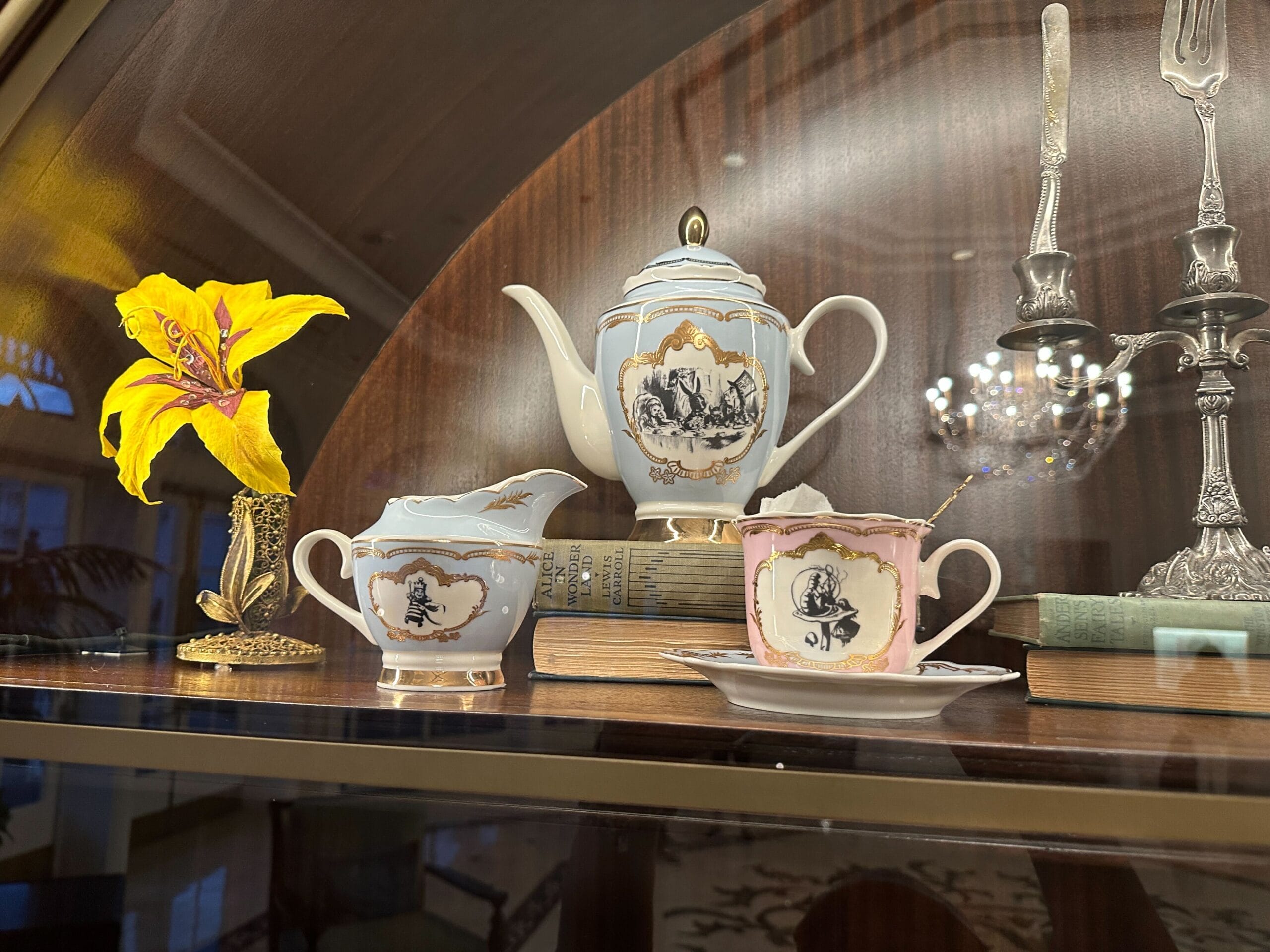 Pastel hued teapot, creamer, and teacup in a glass-front display case in the refurbished Grand Floridian lobby bar. Pastel hued teapot, creamer, and teacup in a glass-front display case in the refurbished Grand Floridian lobby bar.