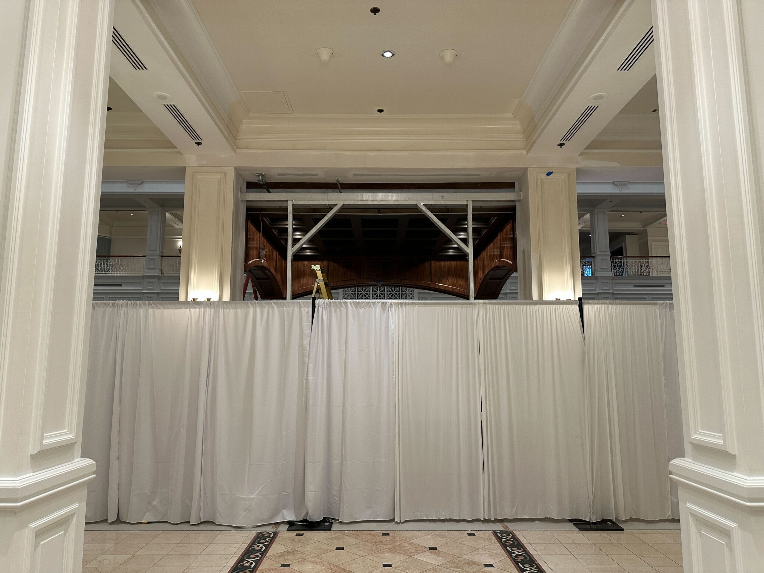 White-curtained barriers hide refurbishments in the lobby of Disney's Grand Floridian Resort. White-curtained barriers hide refurbishments in the lobby of Disney's Grand Floridian Resort.