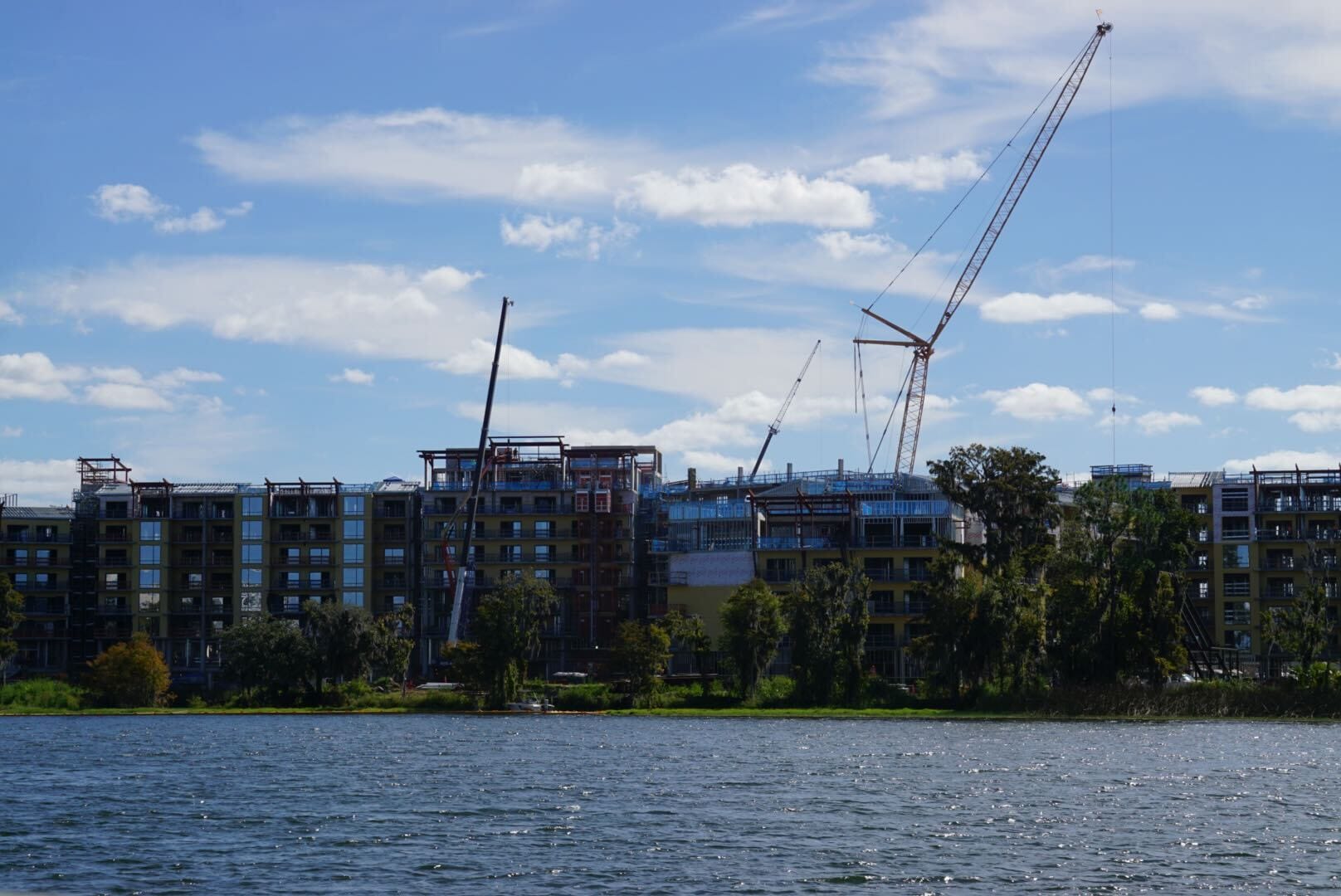 Lakeshore Update: A major structure rising by the water, with cranes and trees—no Disney castle spires like in Magic Kingdom. Lakeshore Update: A major structure rising by the water, with cranes and trees—no Disney castle spires like in Magic Kingdom.