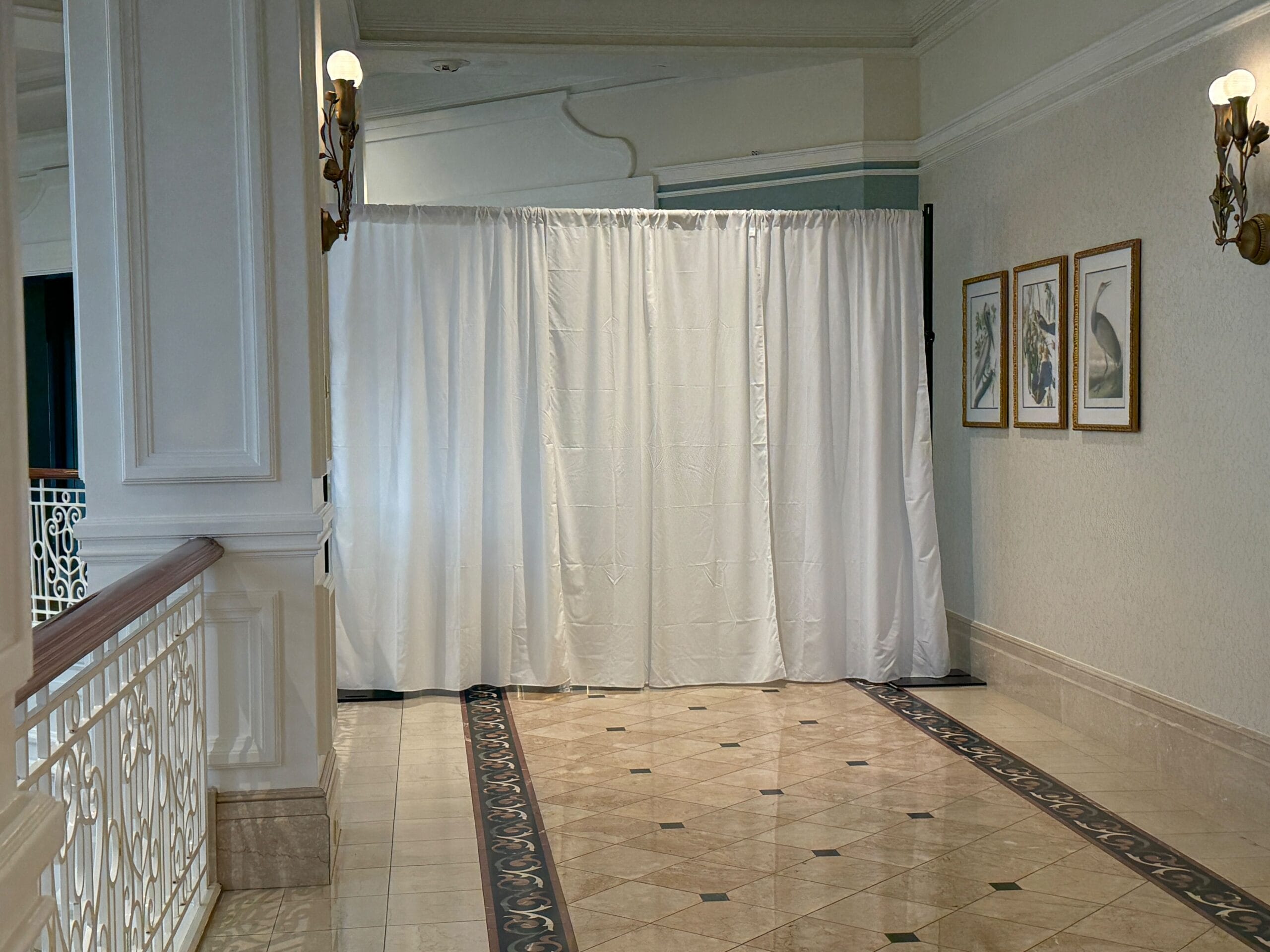 On the second floor, a section of hallway near the Enchanted Rose Lounge is closed. White curtains keep guests away. On the second floor, a section of hallway near the Enchanted Rose Lounge is closed. White curtains keep guests away.