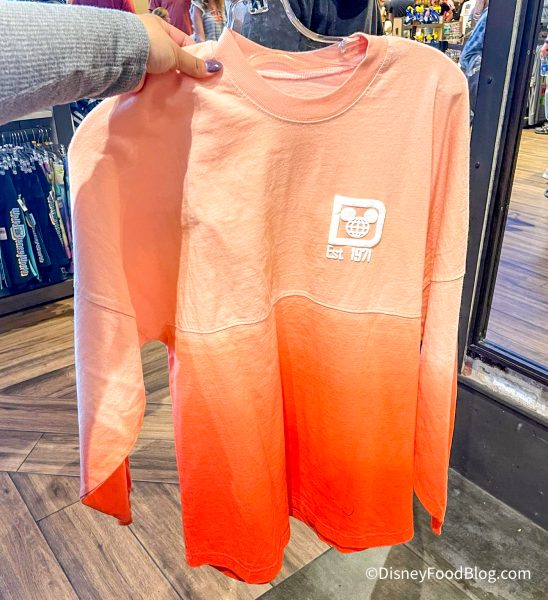 2022-wdw-disney-springs-world-of-disney-store-ombre-orange-spirit-jersey-1-548x600.jpg