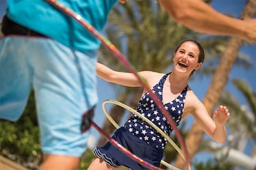 Two children hula hoop by the pool at Cabana Bay Beach Resort in Universal Orlando.